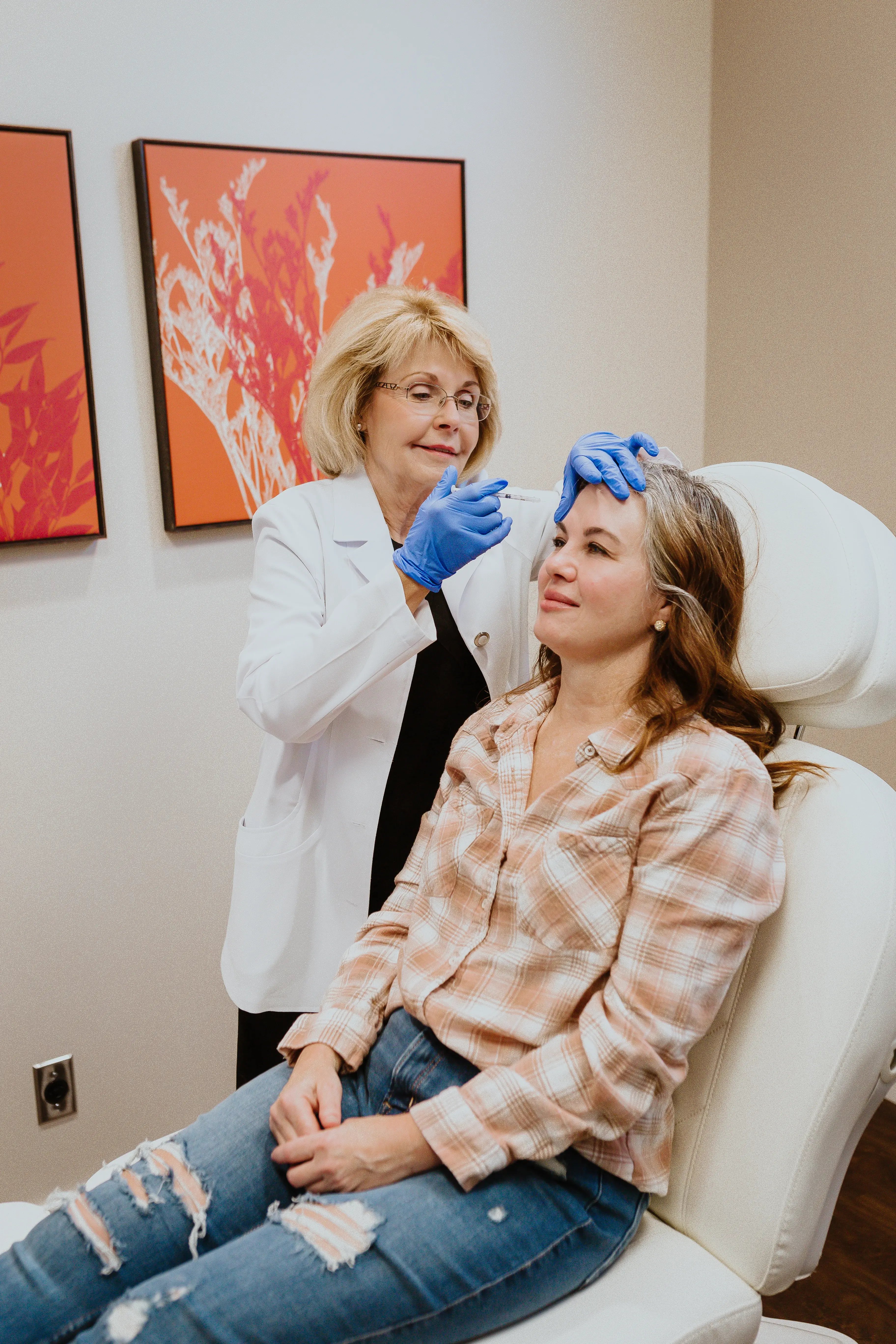 photo-doctor-injecting-forehead-patient-seated-clinic-chair-sculptra-vs-filler-consultation-woman-smiling-practitioner-blue-gloves-wall-art-background